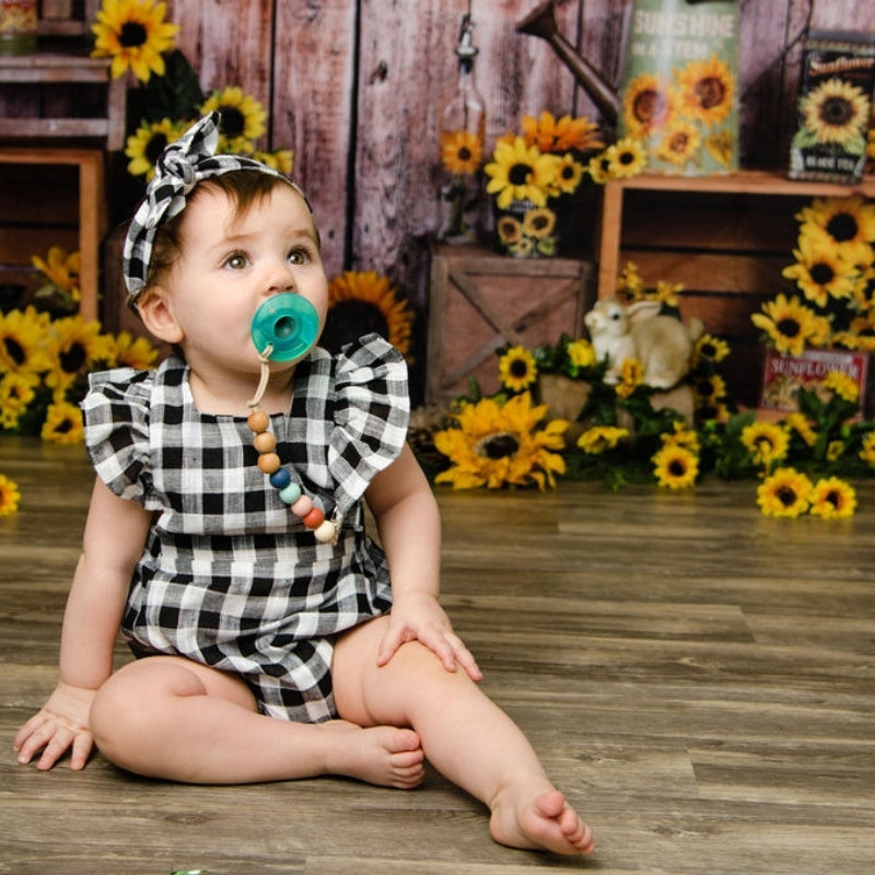 baby girl wearing our buffalo plaid romper and head band 