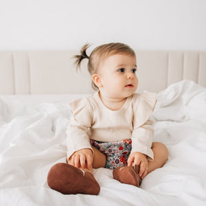 baby girl rearing our long sleeve bodysuit